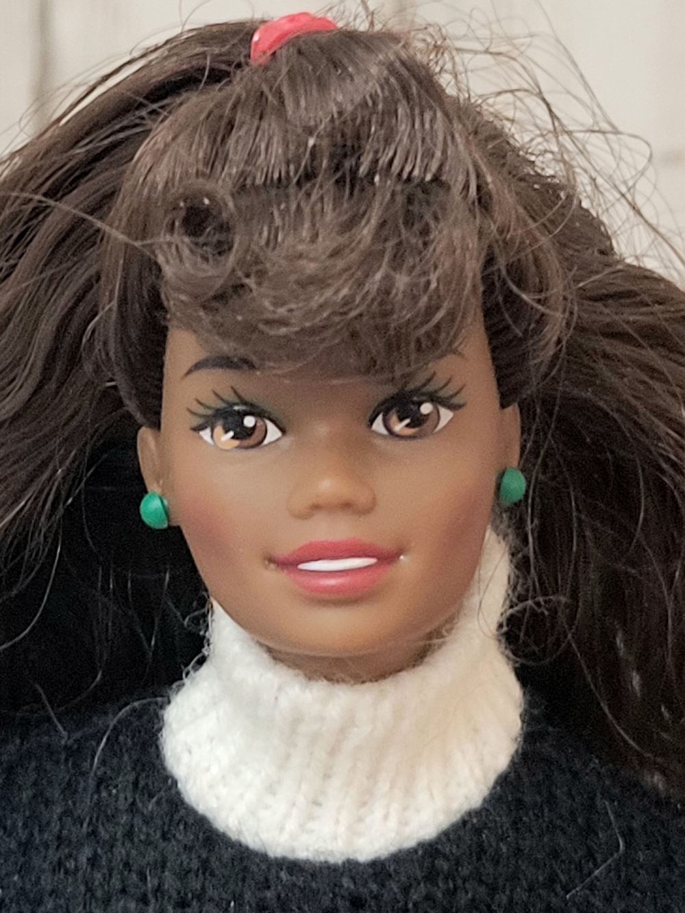 Brunette Doll with Green Stud Earrings and White Turtleneck